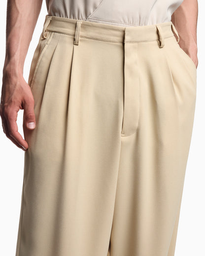 Fluid sandblasted fabric trousers with pleats