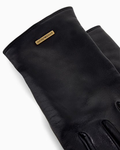 Leather gloves with a metal logo plate and wool lining