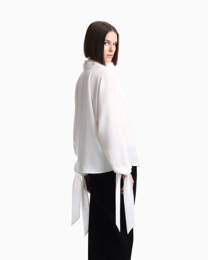 Blouse in recycled crepe with high neckline and tie cuffs