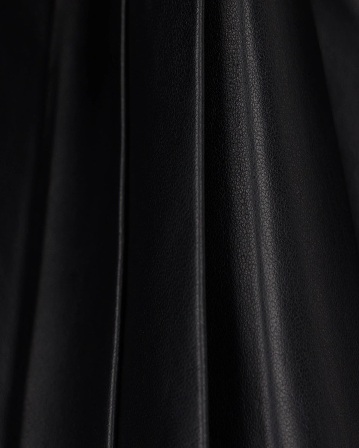 Flared leather miniskirt with front pleats and dual belts