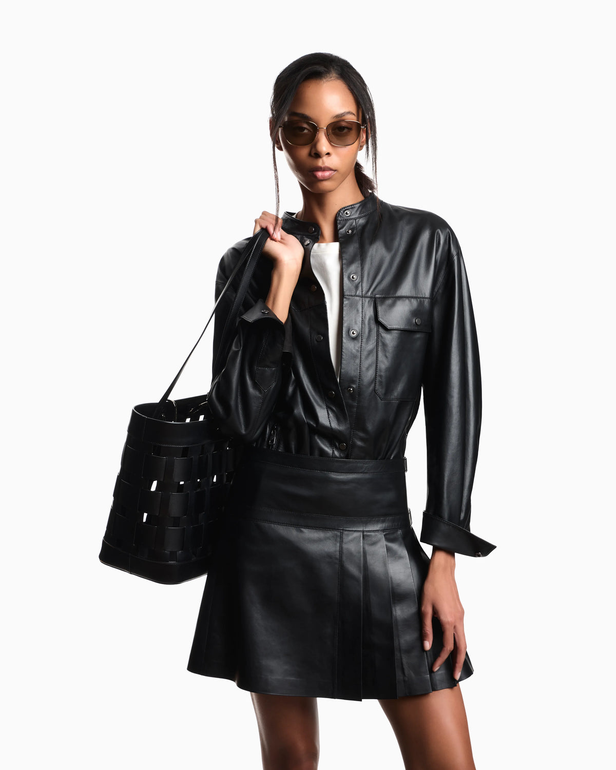 Flared leather miniskirt with front pleats and dual belts