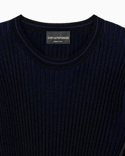 Knit top with asymmetrical and sleeveless ribbed design and pleated panel