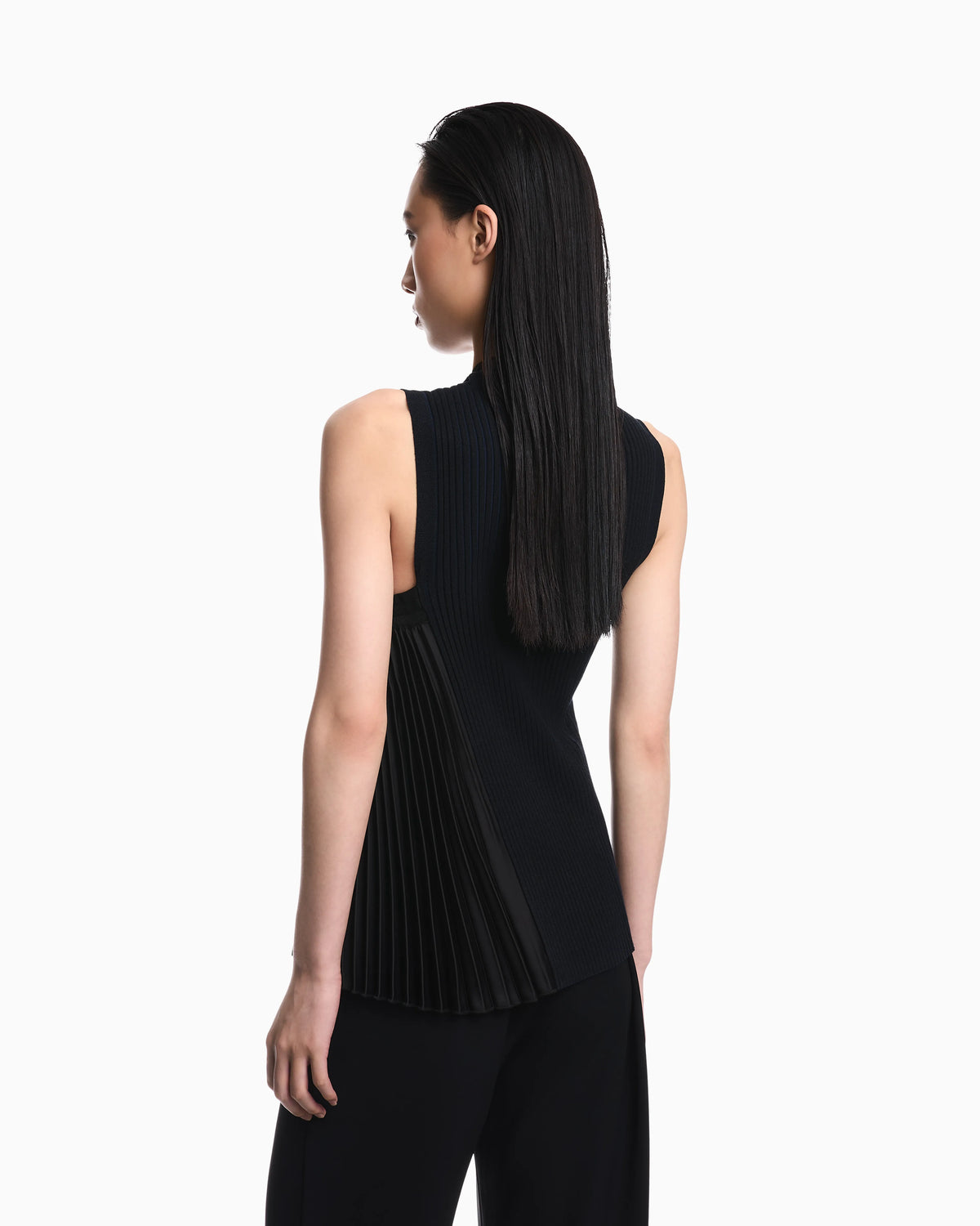 Knit top with asymmetrical and sleeveless ribbed design and pleated panel