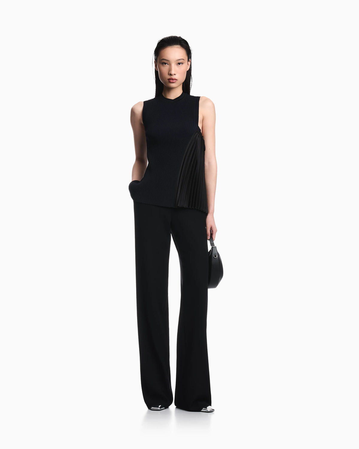 Knit top with asymmetrical and sleeveless ribbed design and pleated panel