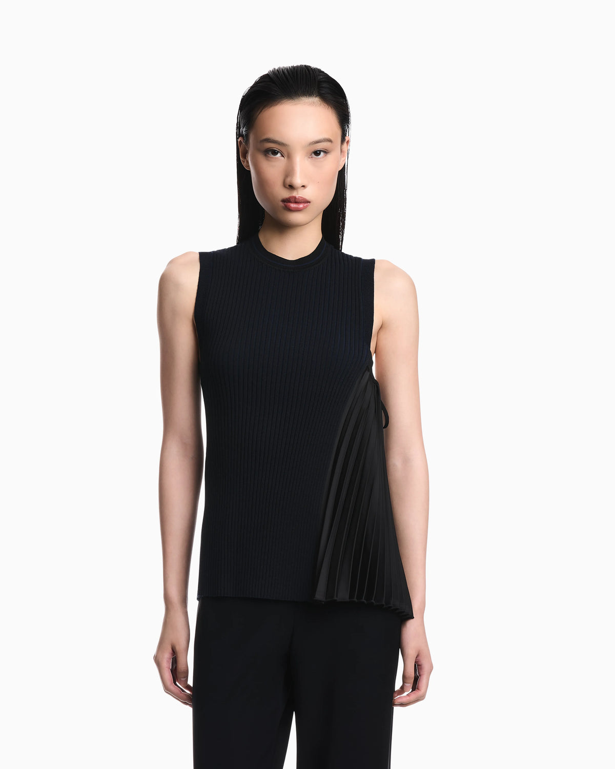 Knit top with asymmetrical and sleeveless ribbed design and pleated panel