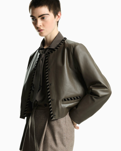 Cropped leather jacket with braided trim and button closure