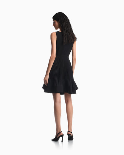 Dress in technical fabric with a pleated skirt