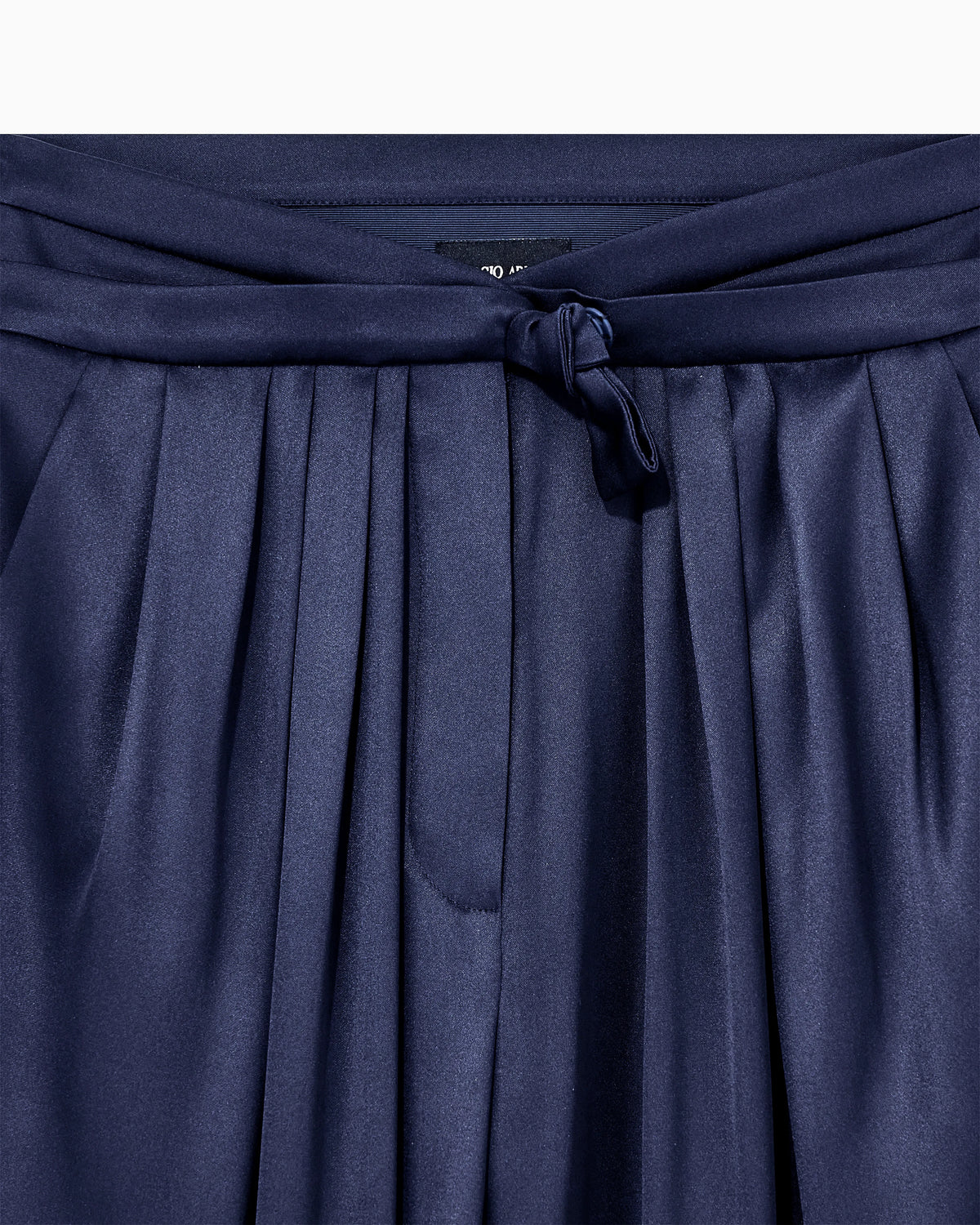 Multi-pleated trousers in silk satin with a waistband knot