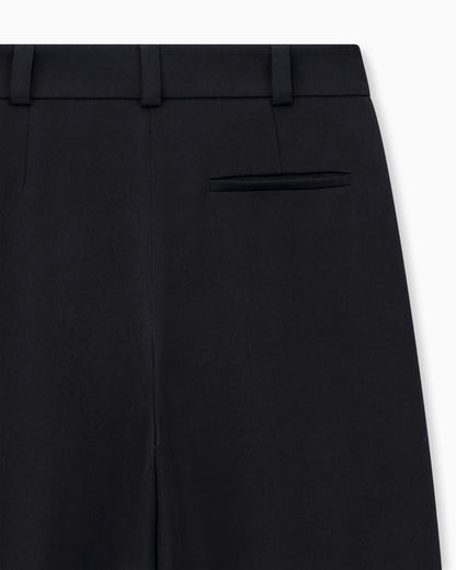 Flat front tuxedo wool trousers with a hidden side pleat
