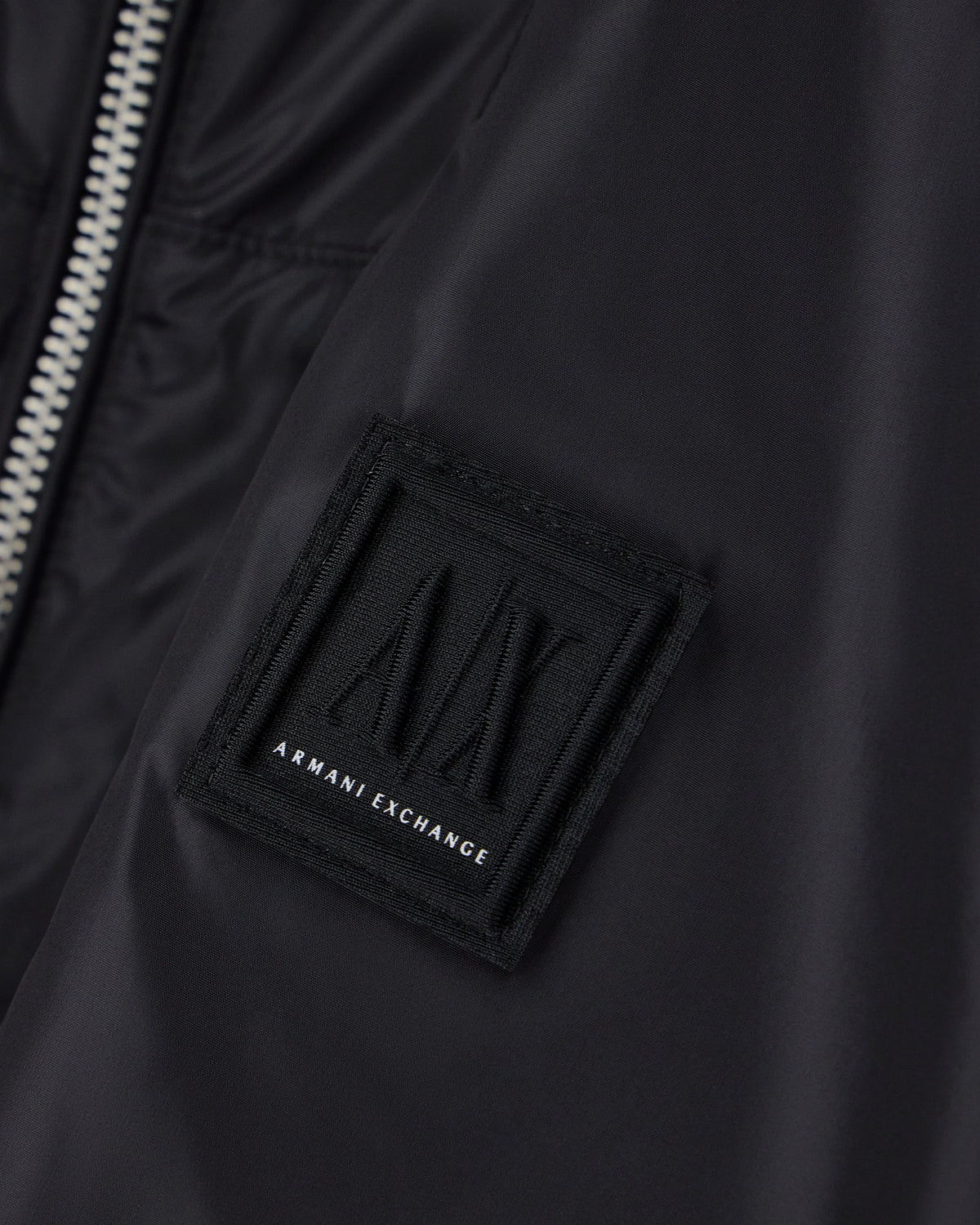 Hooded nylon windbreaker Icon with a zip and logo patch