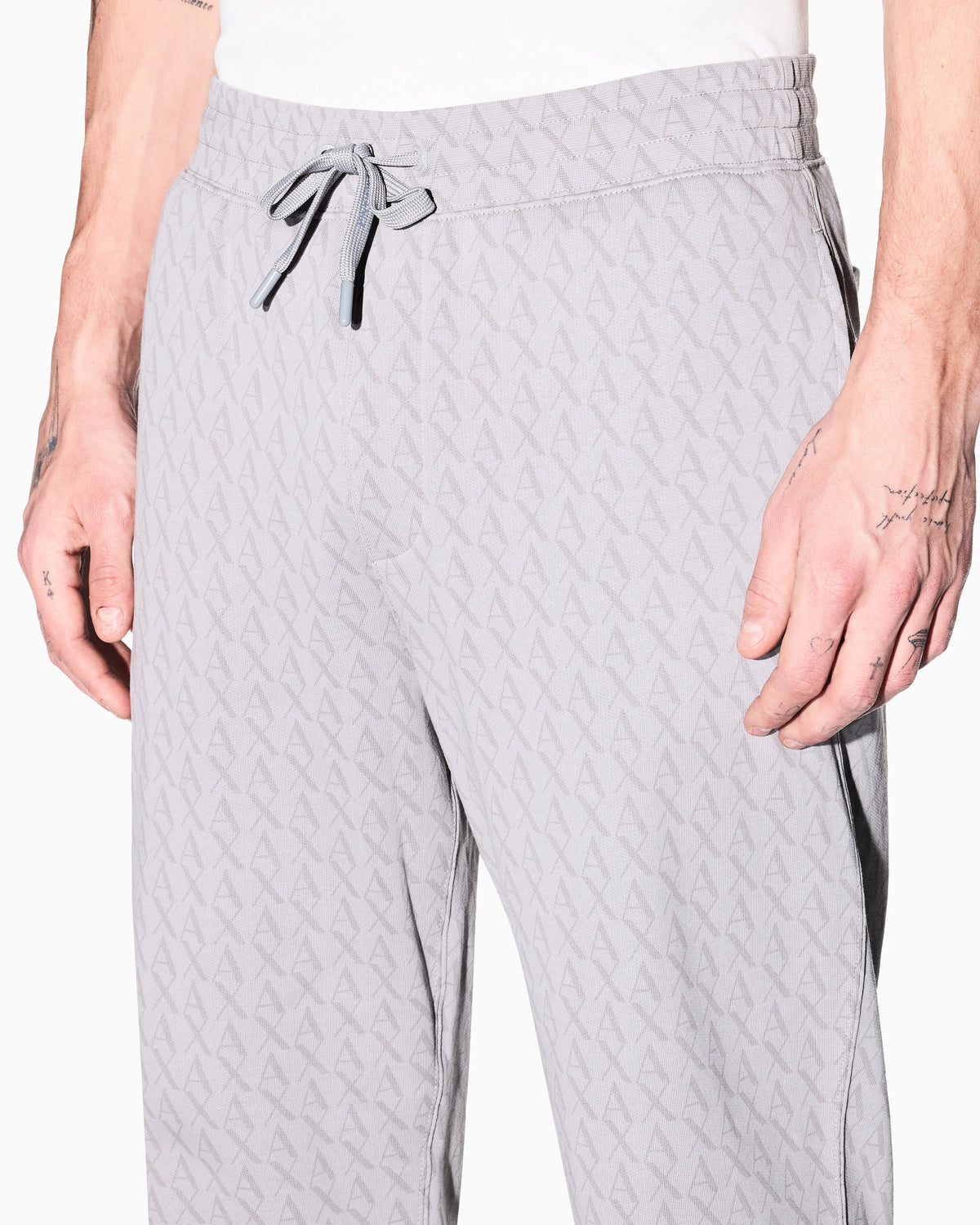 Jogger pants in cotton with all-over monogram Essential