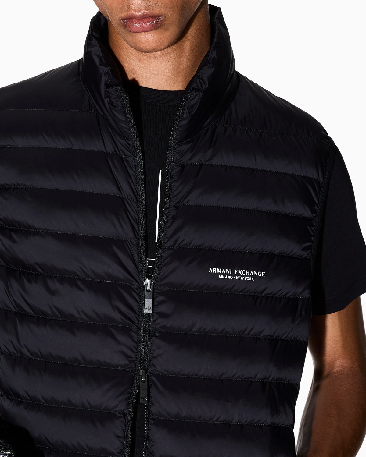 Quilted full-zip down vest with a high collar Essential