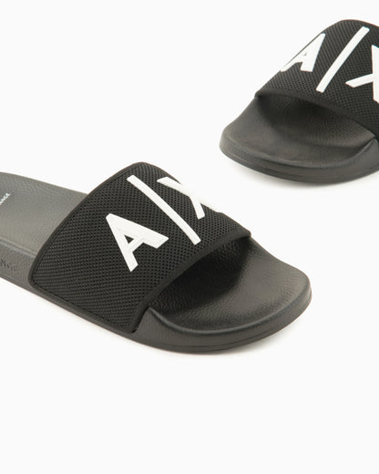 Slide sandals with a wide strap and textured rubber sole