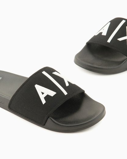 Slide sandals with a wide strap and textured rubber sole