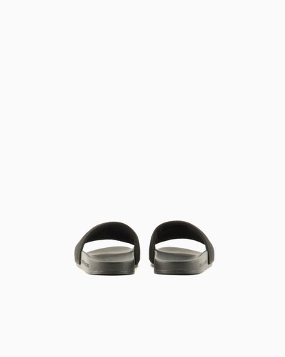 Slide sandals with a wide strap and textured rubber sole