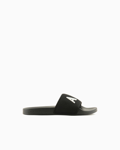 Slide sandals with a wide strap and textured rubber sole
